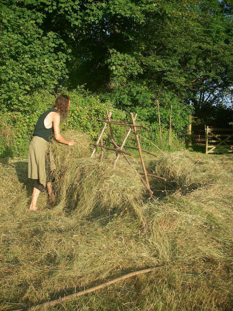 Phil putting on the first layer of hay on a rack